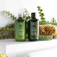 Green glass bottles of Paul Mitchell Shampoo products in an informative guide.