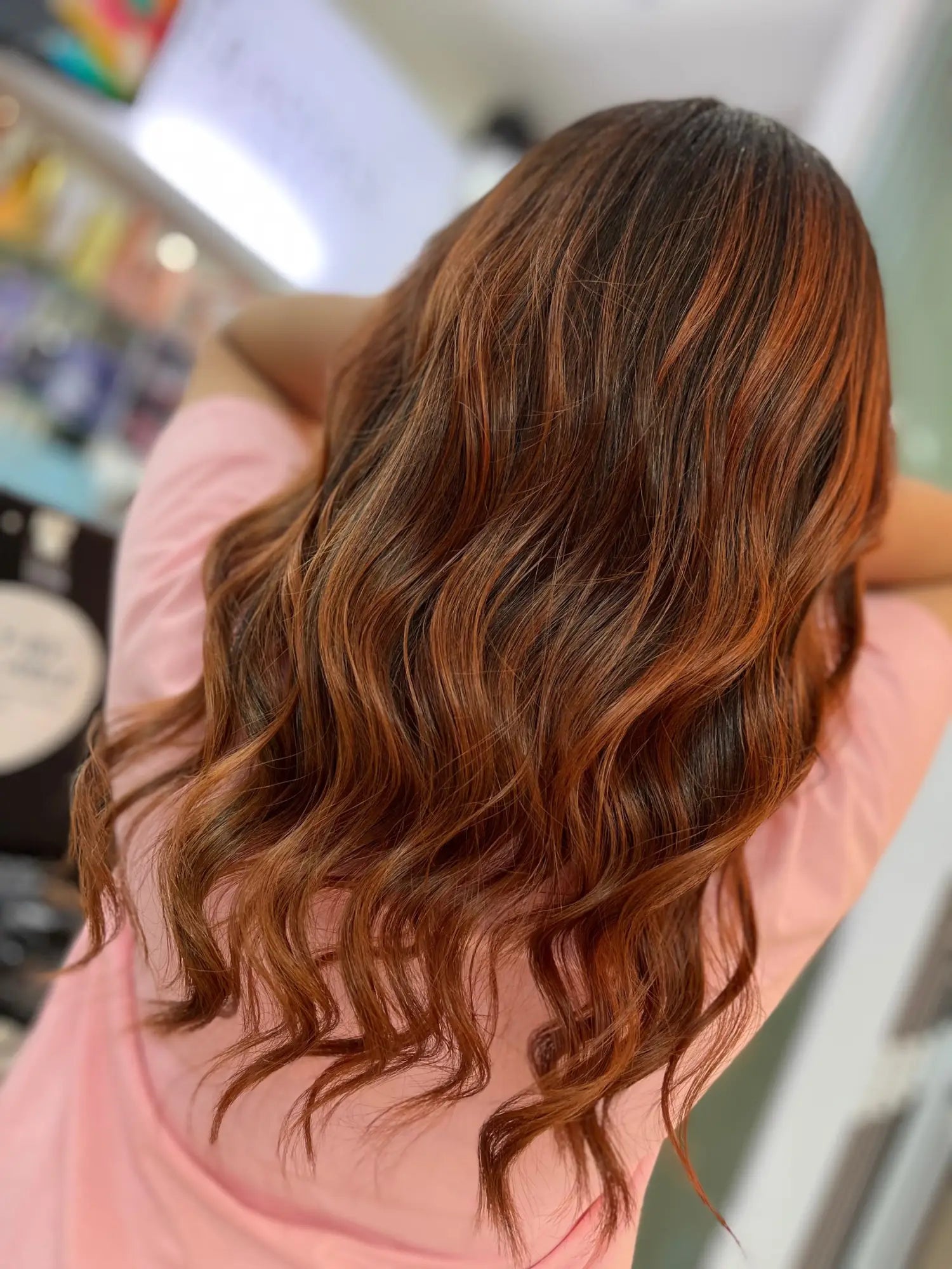 Long, wavy brown hair with reddish highlights for healthy hair care tips.