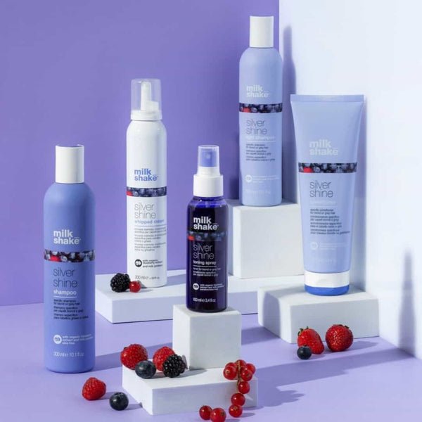 Collection of Milkshake hair care products with fresh berries for maintaining healthy hair
