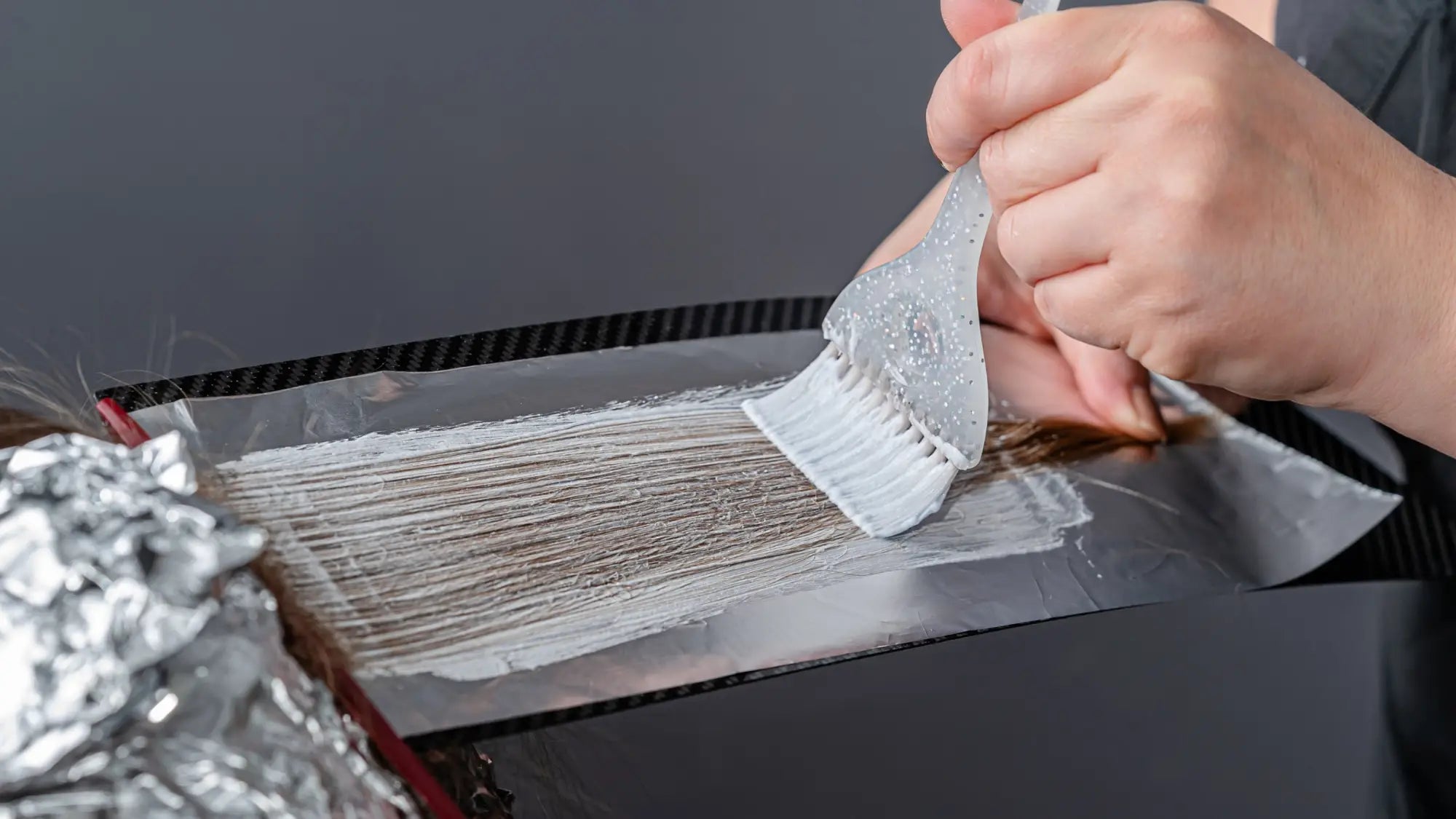 Grater shredding cheese to highlight creativity in color techniques at Partners Hair Design.
