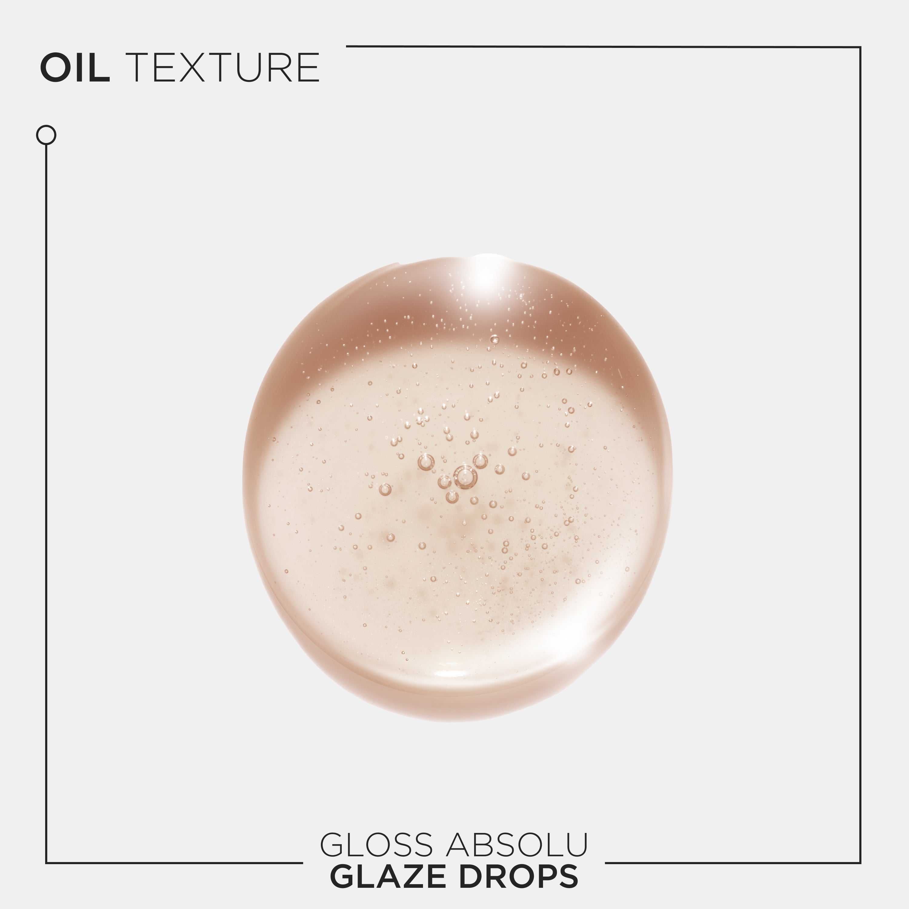Kerastase Gloss Absolu Glaze Drops hair oil. Translucent light amber drop with bubbles.