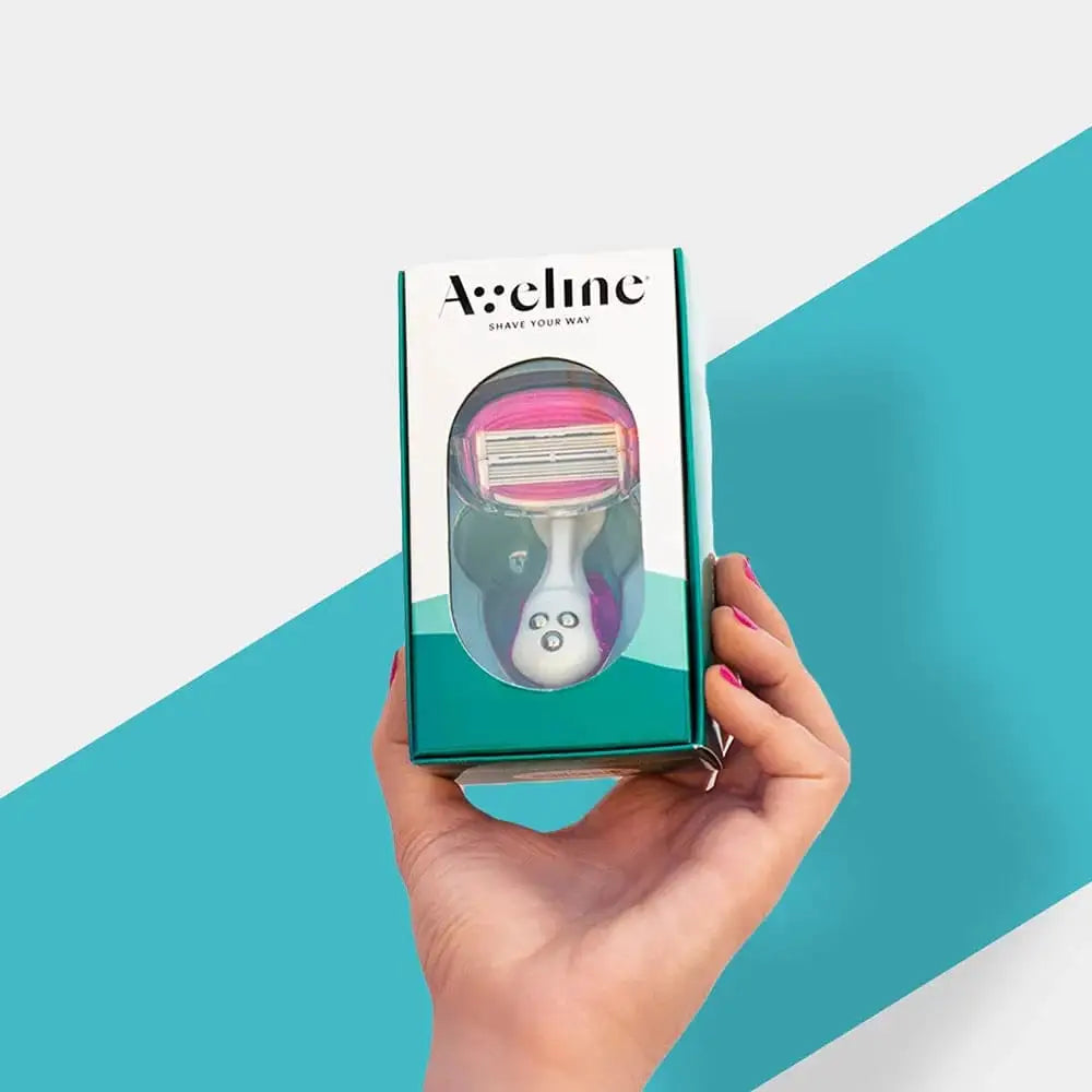 Aveline Ladies Razor: Precision leg & body shaving for women. Smooth skin, irritation-free shave. Hand holding the razor box.