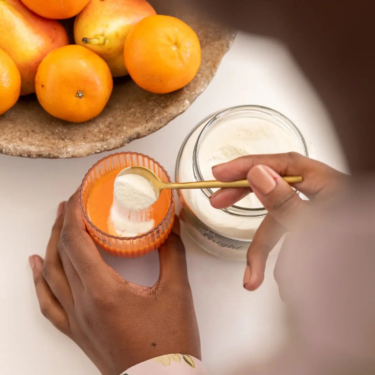 Mixing Be Bright Luminate Collagen Powder Shot 10g with water for a glowing skin boost. Perfect for on-the-go wellness!