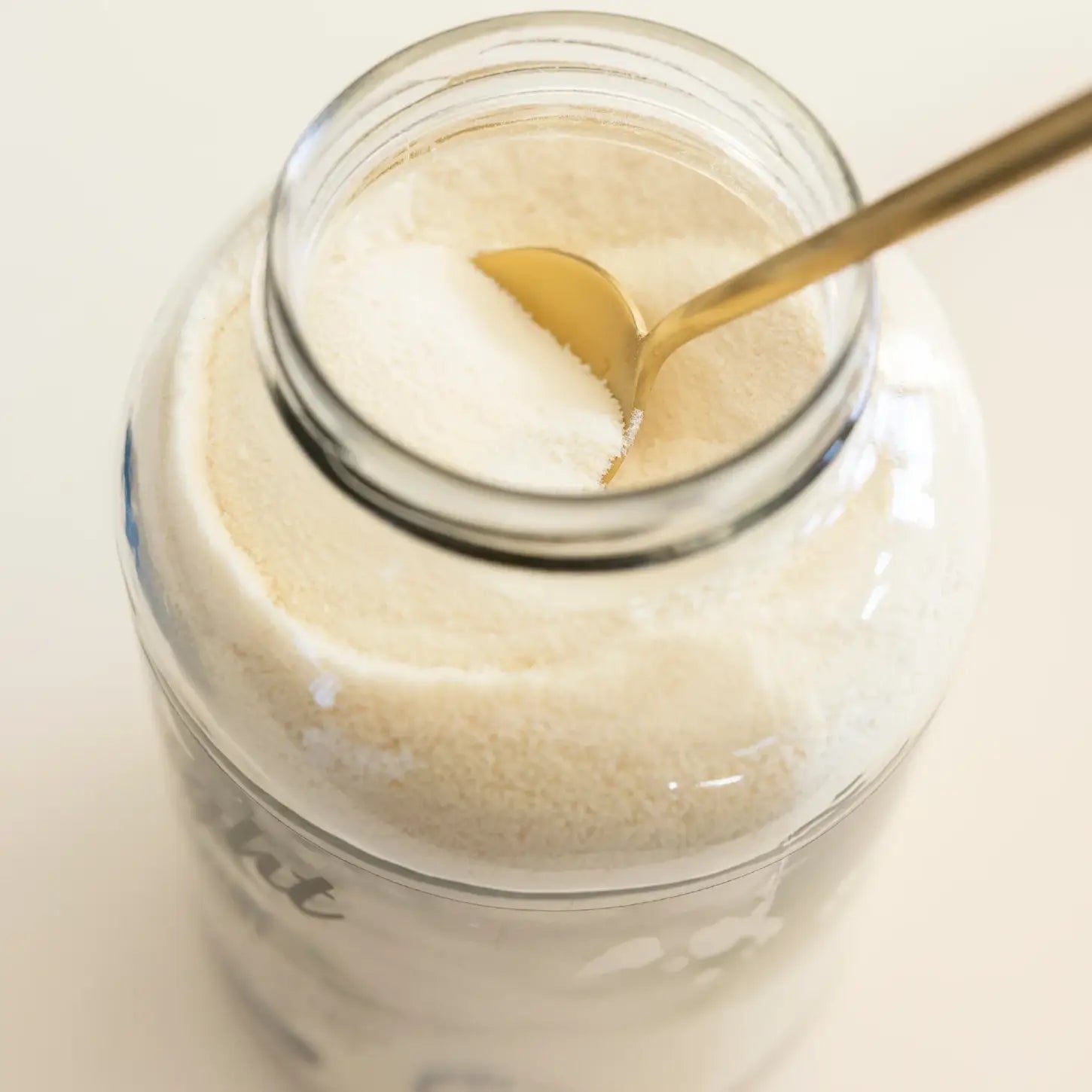 Be Bright Original Collagen Powder 350g in a jar with a gold spoon, showcasing its fine, pure collagen texture.