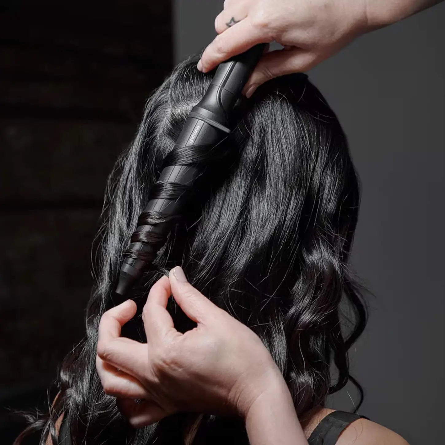 ghd Curve Creative Curl Wand styling long dark hair for deep waves. Hair styling with curling iron.