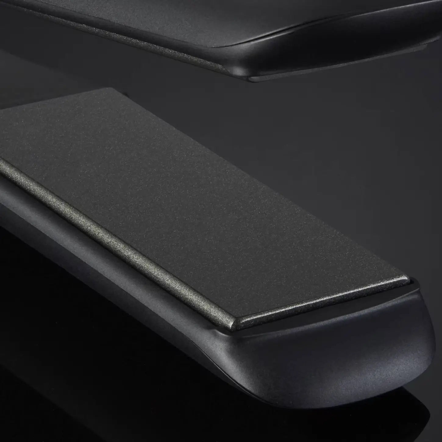 Sleek black armrest of the ghd Max Wide Plate Hair Straightener with smooth curves