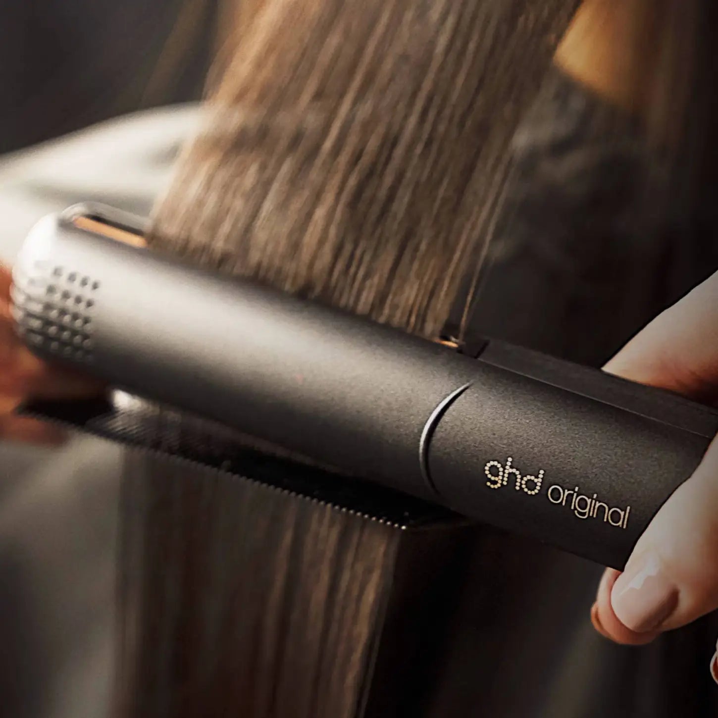 ghd Original Straightener styling long brown hair. Get sleek, straight salon style results with ghd. ghd hair styling tool