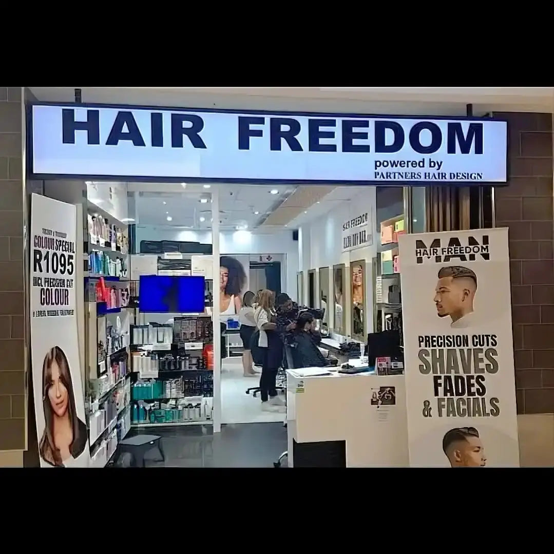 Hair salon storefront with ’HAIR FREEDOM’ signage.