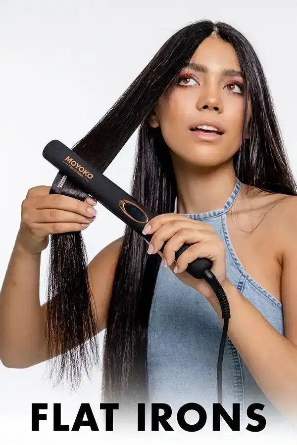 Hair straightener or flat iron being used to style long dark hair.