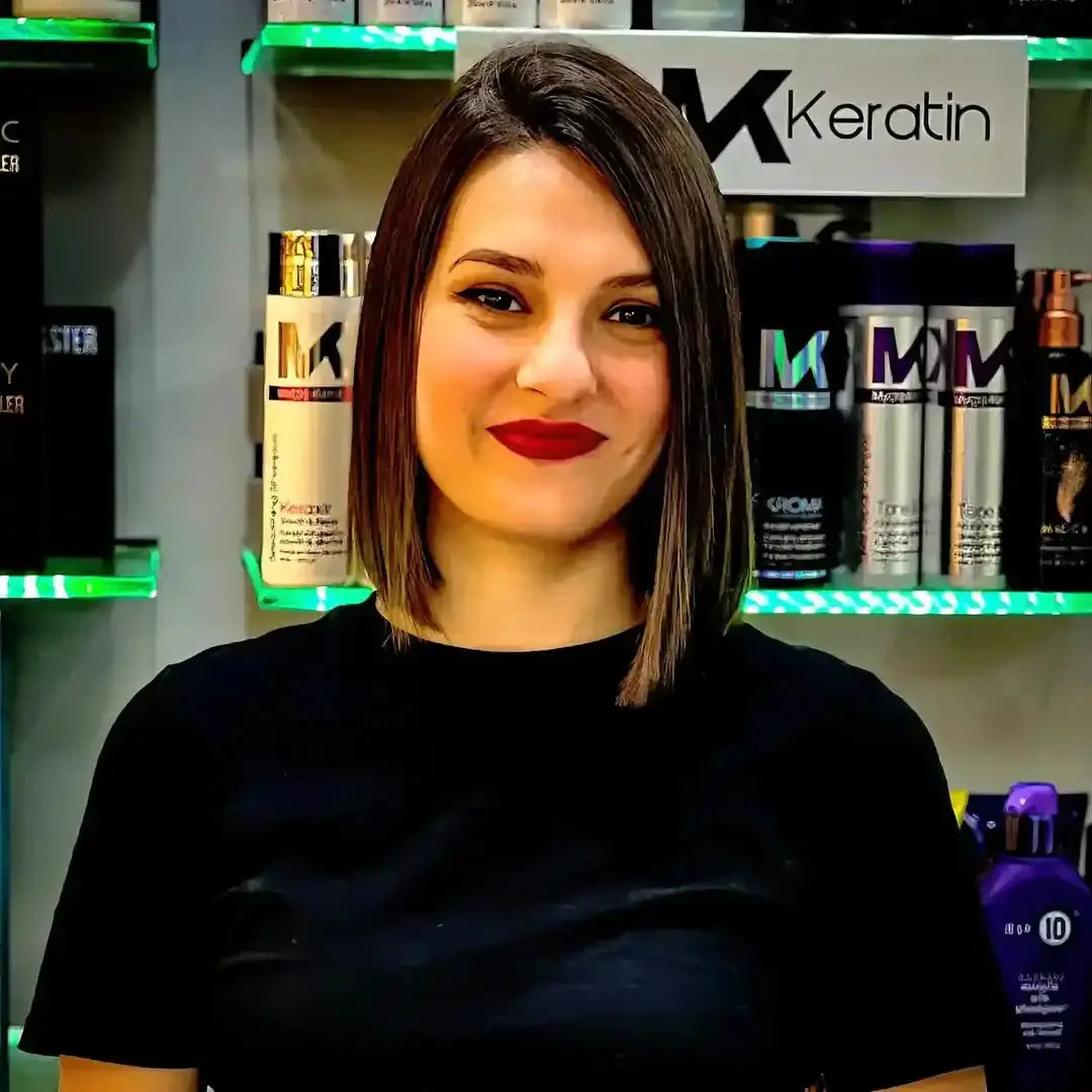 A hairstylist wearing a black shirt with an asymmetrical bob haircut.