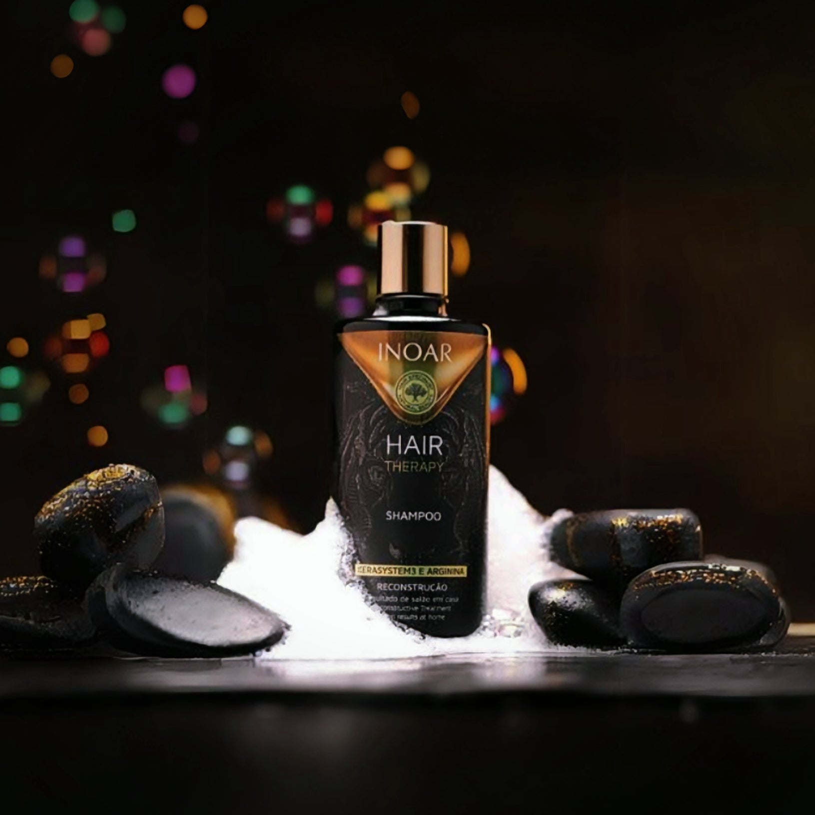 Inoar Hair Therapy Shampoo bottle surrounded by black stones and bubbles for healthy hair care