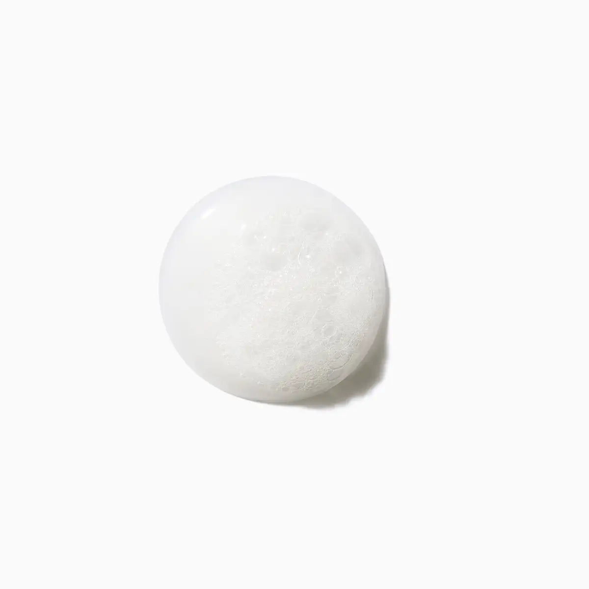 Kerastase Specifique Shampoo Texture: Close-up of a Thick, Foamy Dollop. Ideal for Hair Thinning & Scalp Care.