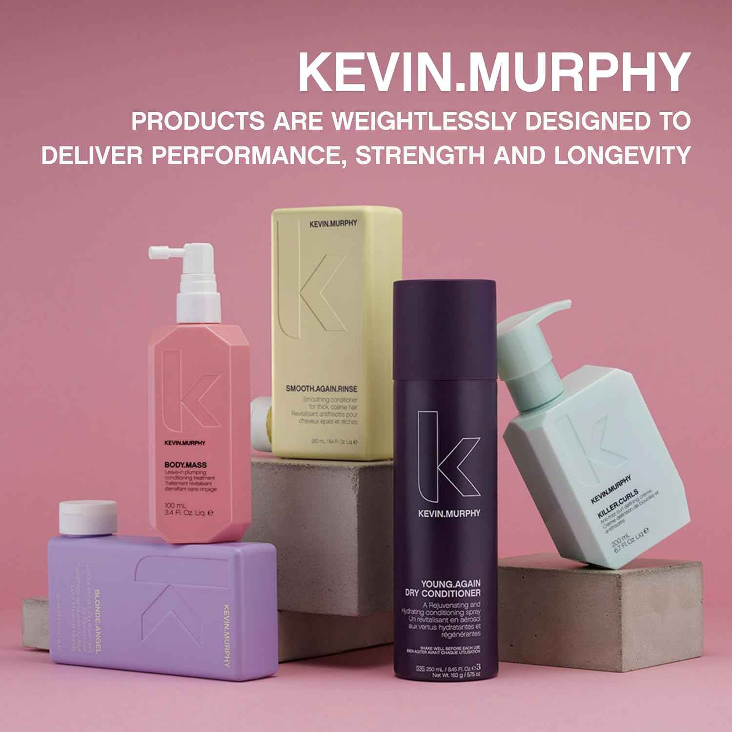 Kevin Murphy Angel.Wash volumizing shampoo alongside other Kevin Murphy hair care products on pink background
