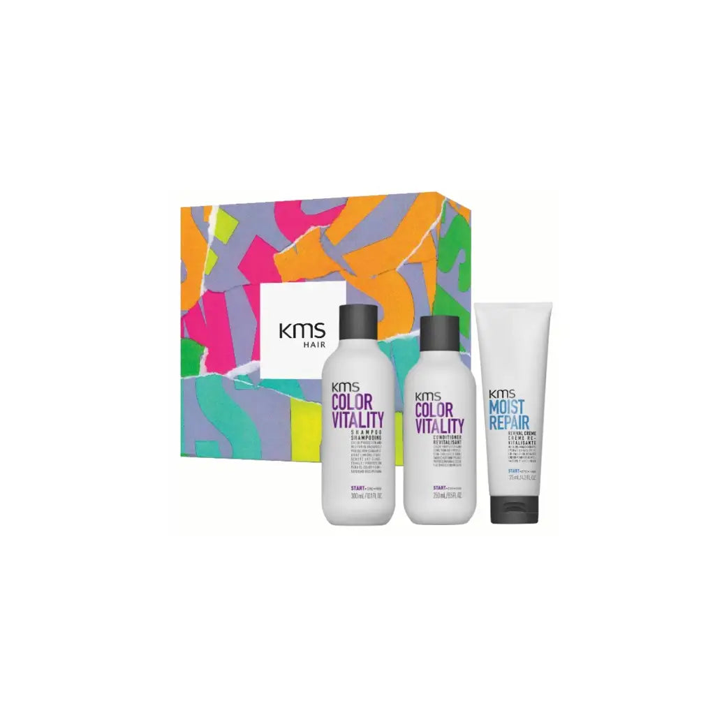 Colorful gift box containing three hair care product bottles from the KMS brand.