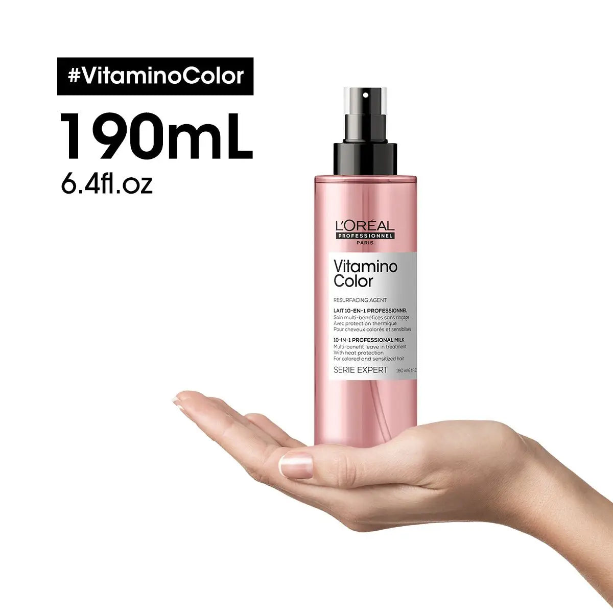 Pink bottle of L’Oreal Vitamino Color 10 In 1 Spray held in open palm - L’Oréal Professionnel