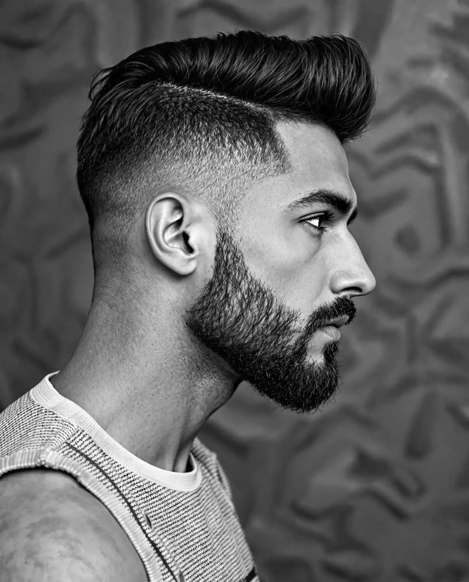Man with a stylish haircut and beard.
