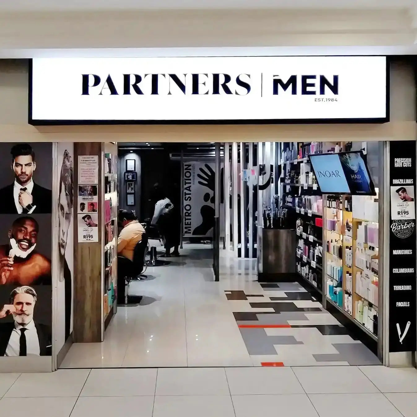 Men’s fashion retail store entrance with ’PARTNERS MEN’ signage.