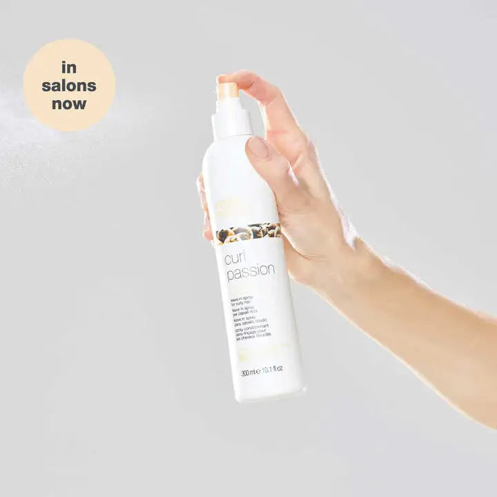 Milkshake Curl Passion Leave-in Treatment for Curly Hair: Hand holding spray bottle. Buy Now!