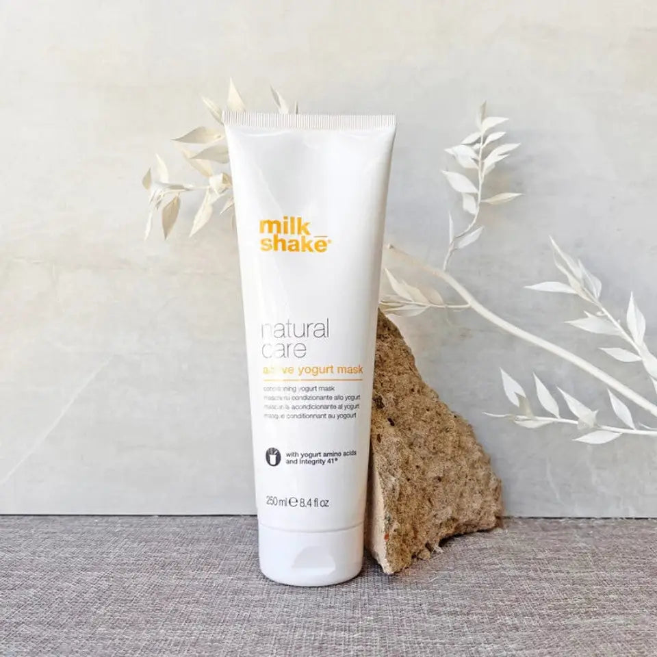 Milkshake Active Yogurt Mask natural care treatment tube next to beige decorative rock and white leaves