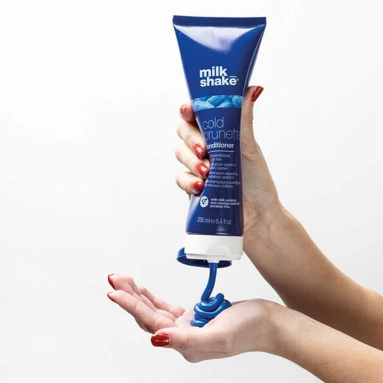 Milkshake Cold Brunette blue conditioner being dispensed. Brunette hair care, color enhancing conditioner.