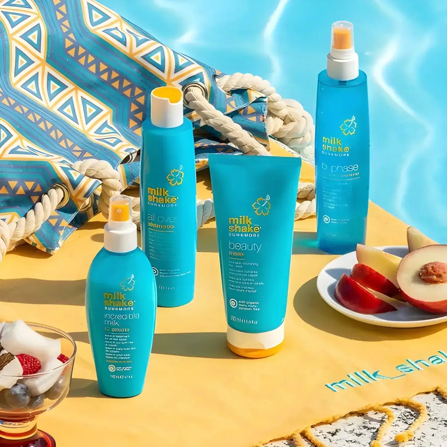 Milkshake Sun & More: Haircare Set with SPF, Detangler, and Frizz Control. Beachy turquoise hair products on bright yellow surface.