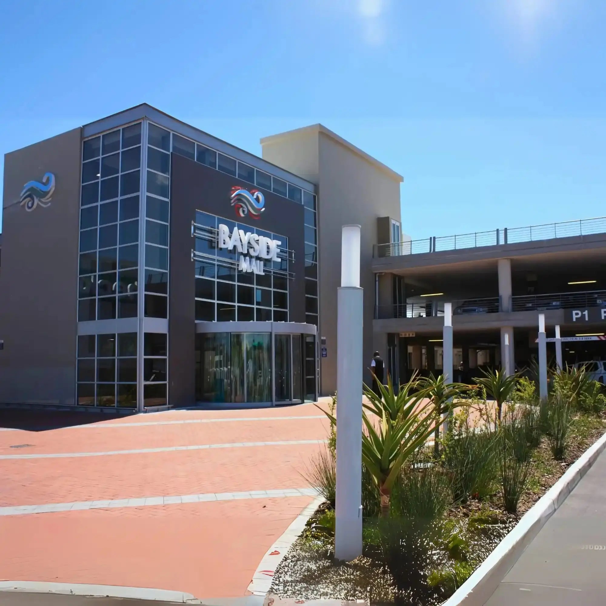 Modern office building with ’Bayside’ signage and glass windows.