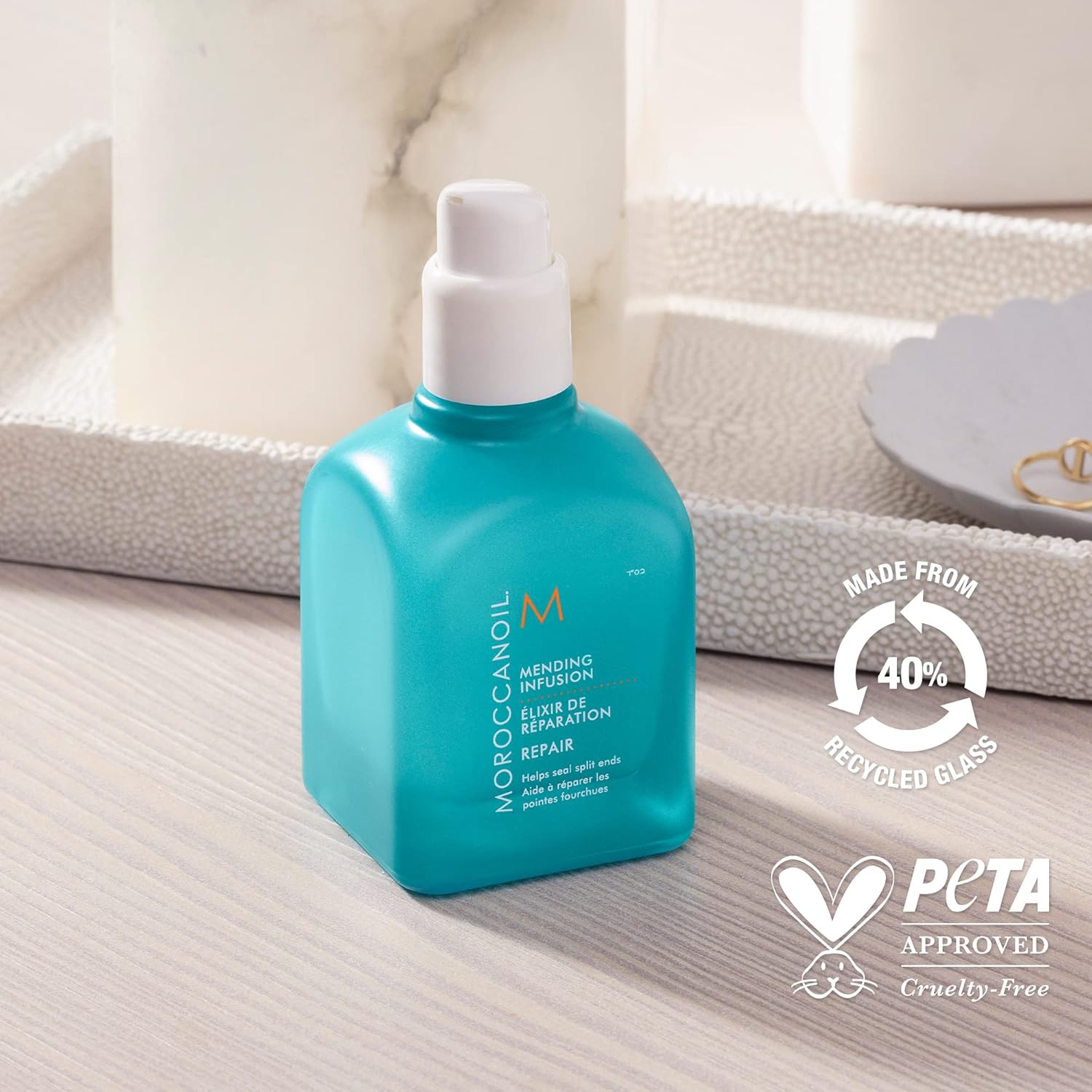 Moroccanoil Mending Infusion Styling Hair Serum in a sleek blue bottle, perfect for repairing split ends and restoring shine.