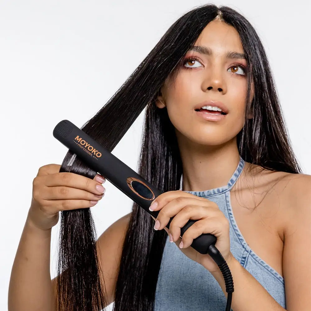 A woman using the Moyoko Classic Styler with ceramic plates and negative ions