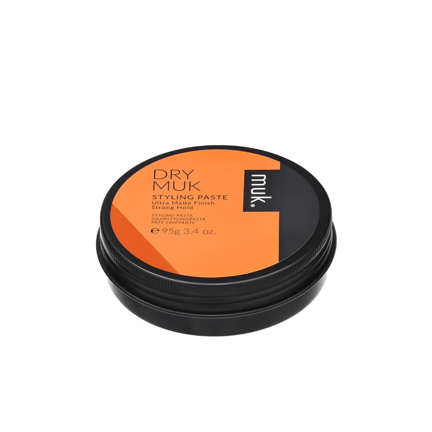 Circular container of MUK Dry Muk Styling Paste with orange and black packaging, 95g
