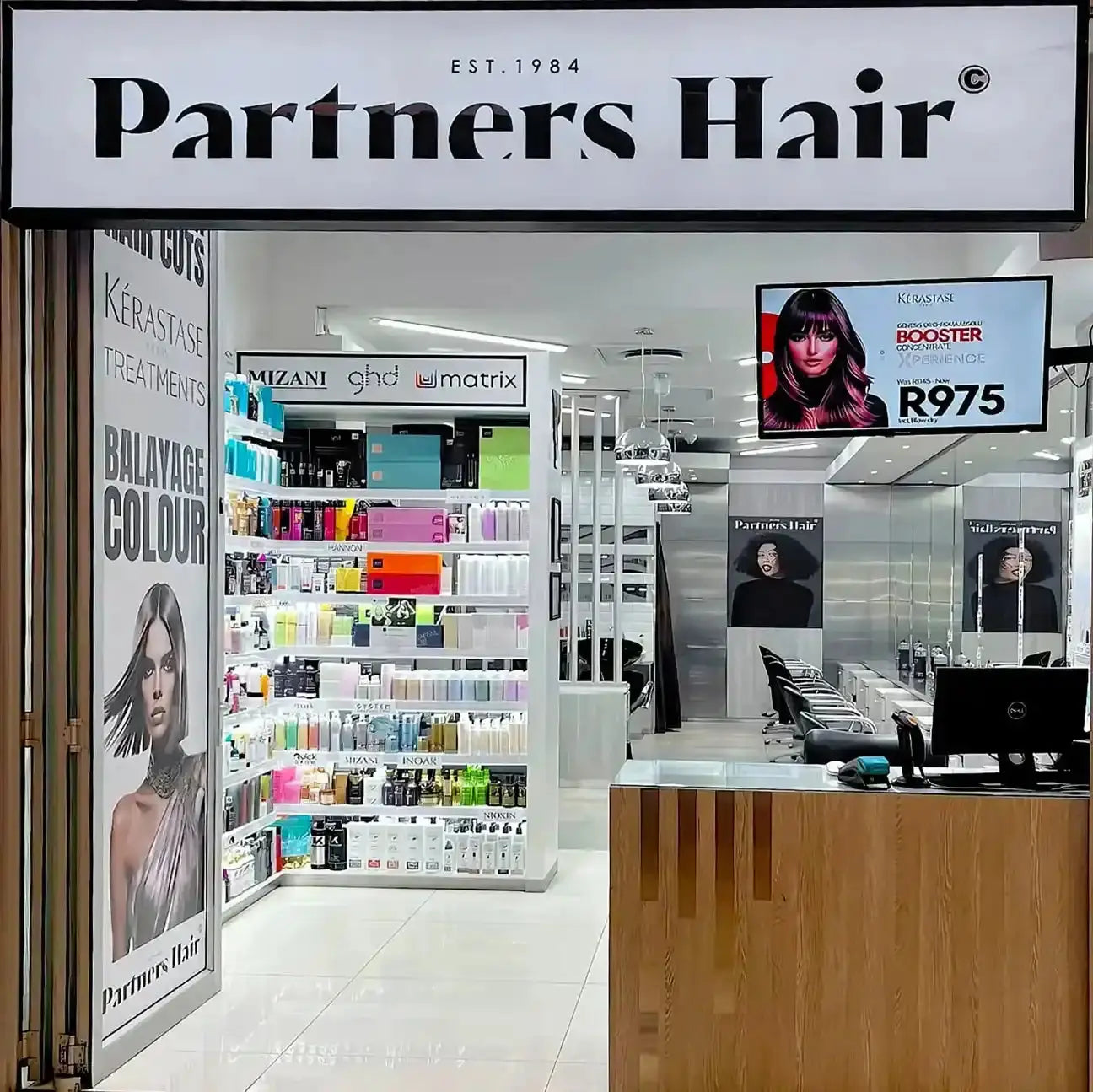 Partners Hair salon storefront with hair product displays and styling stations.