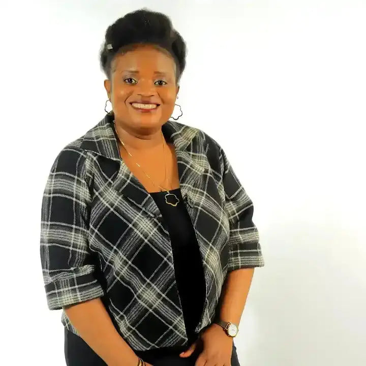 A person wearing a black and white plaid button-up shirt over a black top.