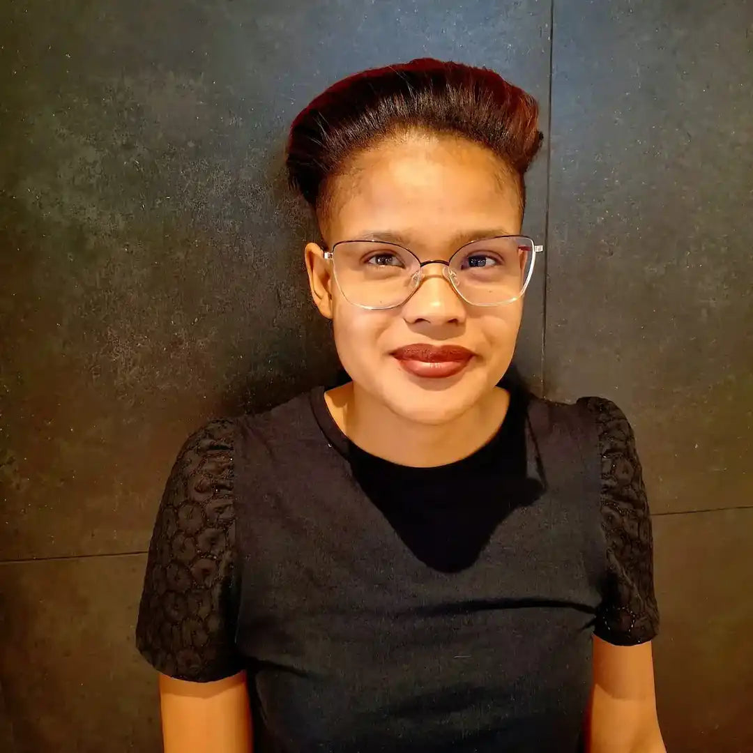 Person with glasses and dark lipstick.