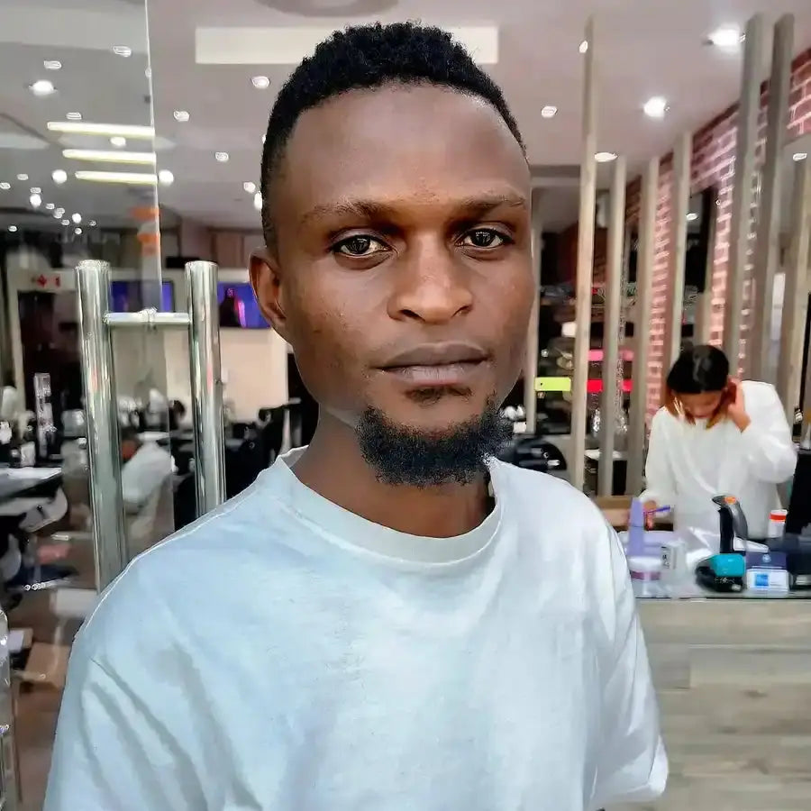 A person wearing a white crewneck sweater in a salon setting.