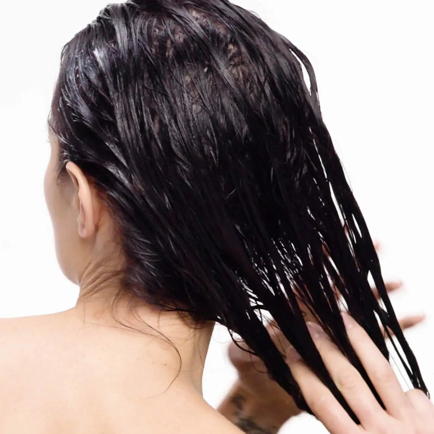 Wet, Dark, Color-Treated Hair being Cleansed with Redken Color Extend Magnetics Shampoo