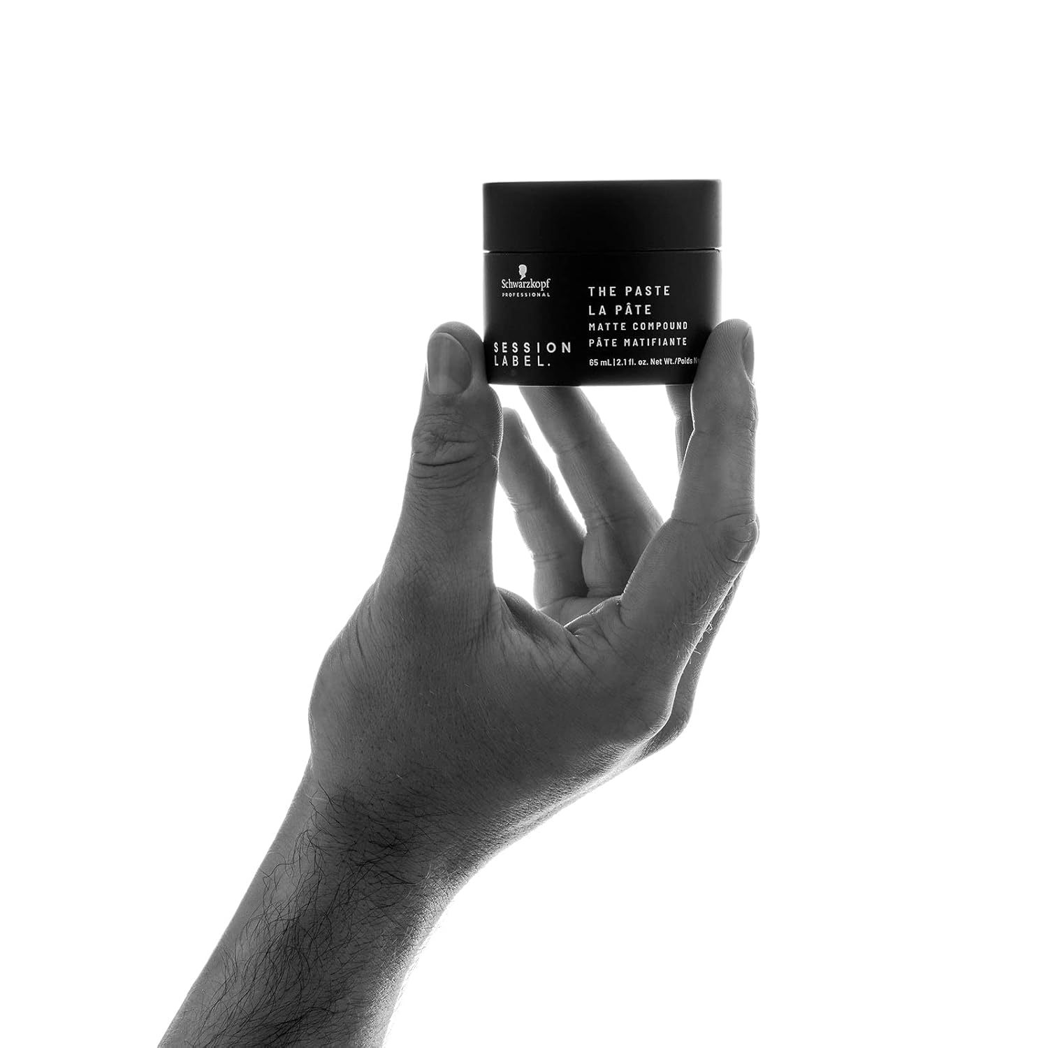 Schwarzkopf The Paste: Matte hair styling paste held in hand. Buy at Partners Hair Design for easy, vegan hair styling.