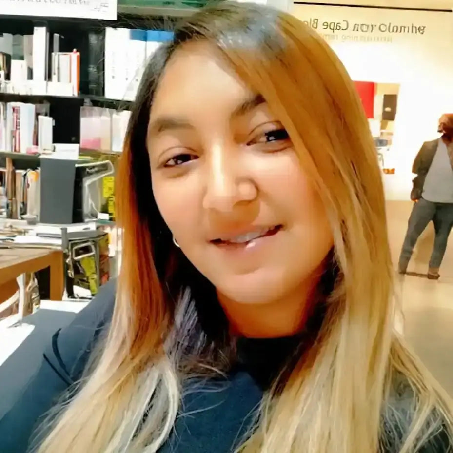 A selfie showing someone with long blonde ombre hair smiling at the camera.