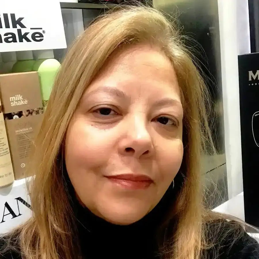 A selfie portrait showing someone with long brown hair wearing a black turtleneck sweater.