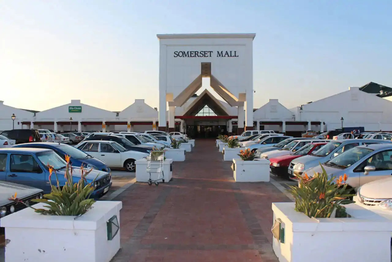 Somerset Mall entrance with white planters lining a brick walkway.