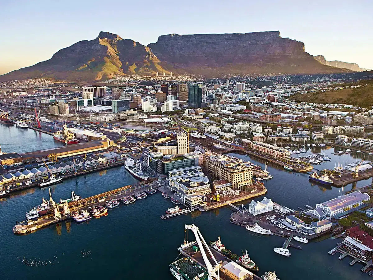 Table Mountain rises dramatically above Cape Town’s harbor and cityscape.