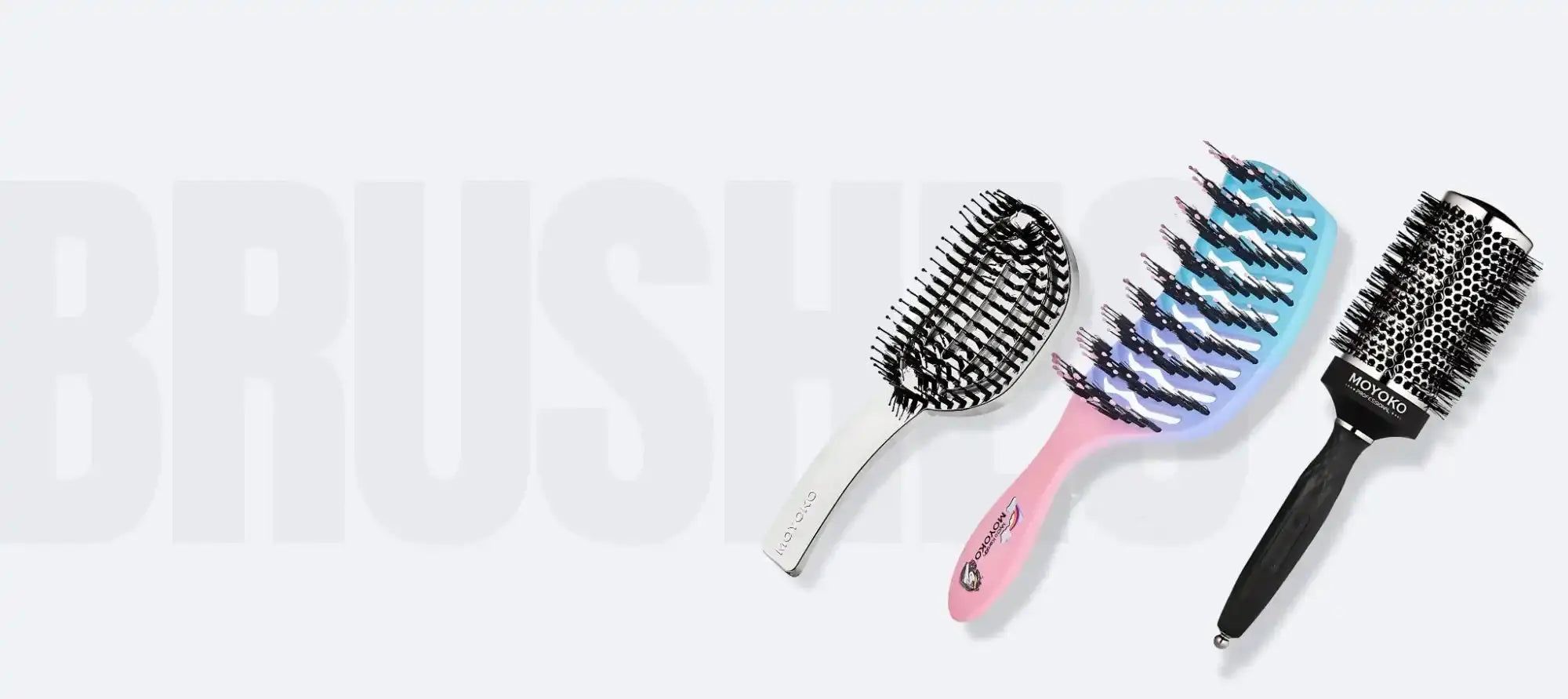 Three different hair brushes with various bristle designs and handle colors.