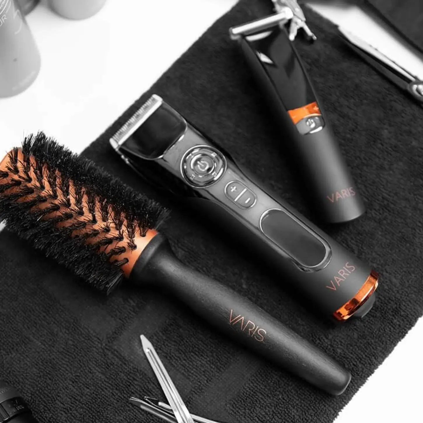 Varis Professional Hair Trimmer, Hair Brush, and Grooming Tools on Black Towel - Precision Haircut, Salon Equipment.