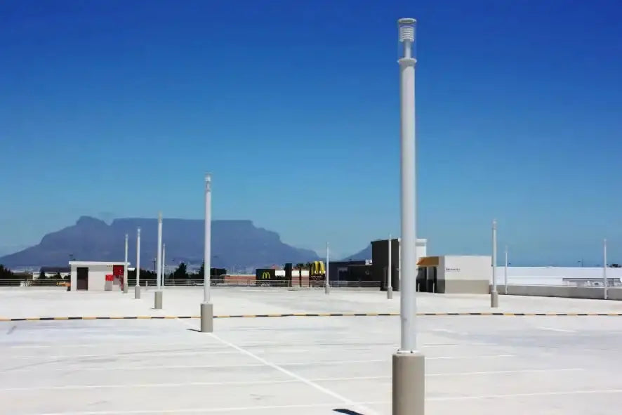 White lamp posts on a concrete surface.