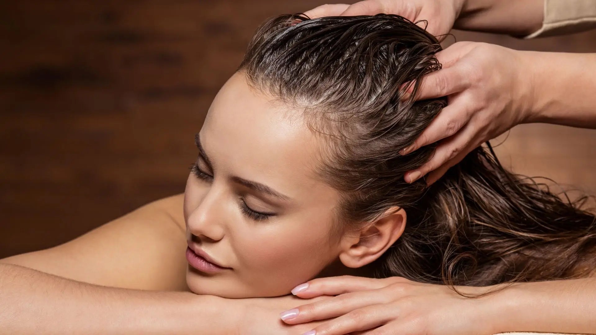 Woman enjoys a relaxing scalp massage, enhancing her sulfate-free shampoo experience.