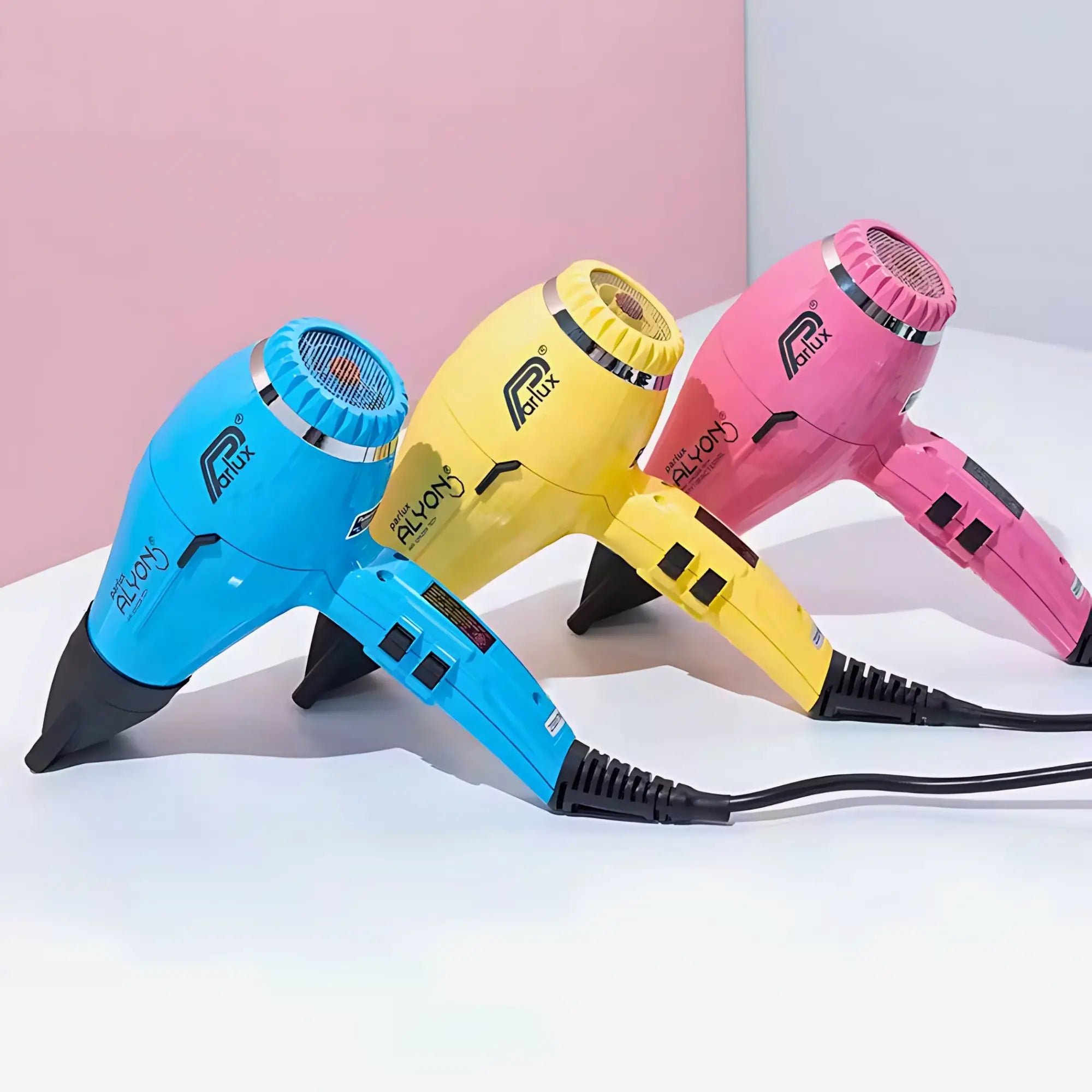 Colorful professional hairdryers in blue, yellow, and pink for salon-quality results