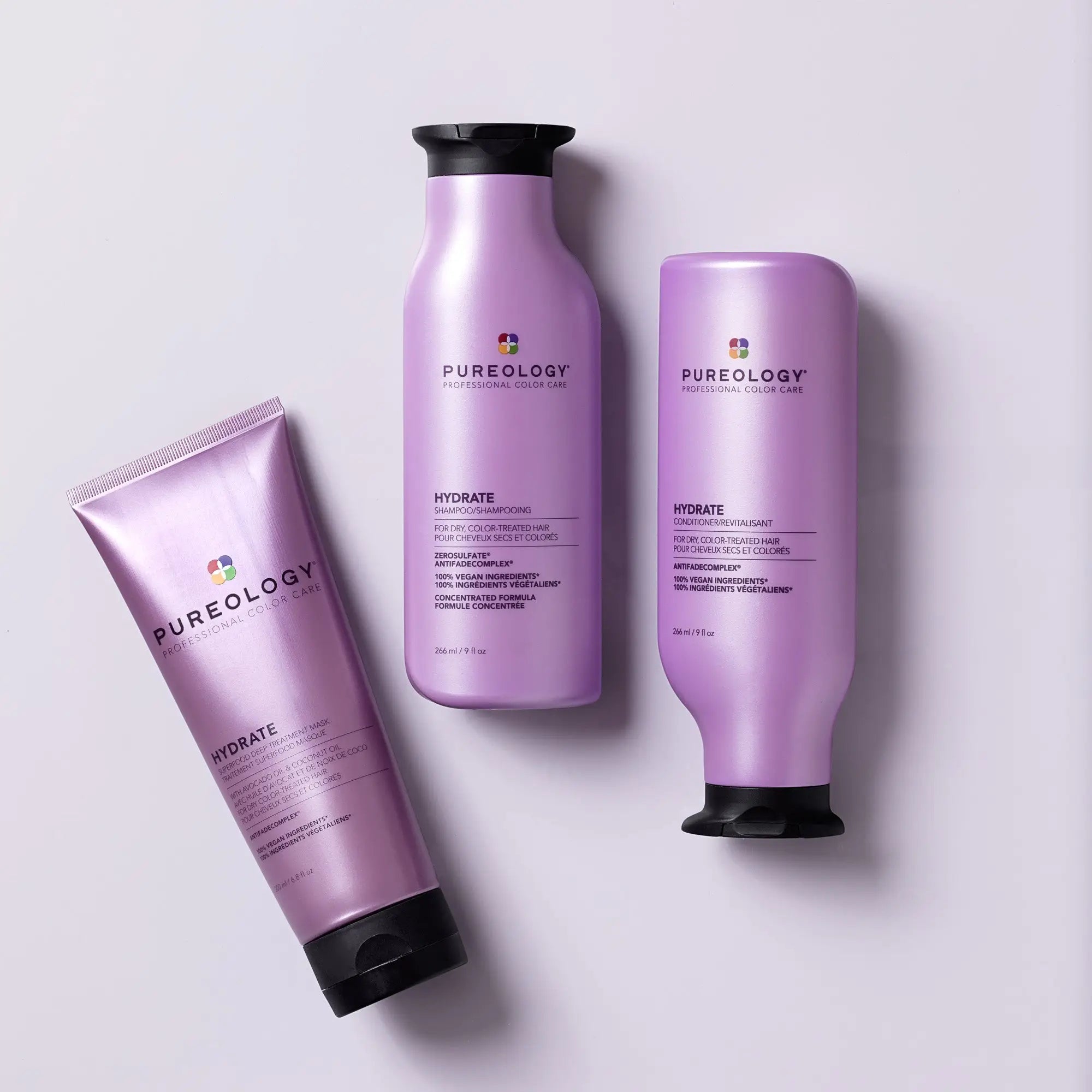 Purple Pureology hair care product bottles for a luxurious hair care routine.