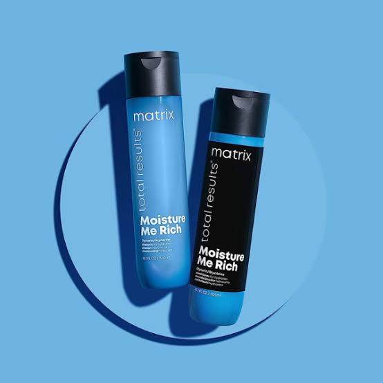 Two blue Matrix Total Results Moisture Me Rich hair products for vibrant, healthy hair.