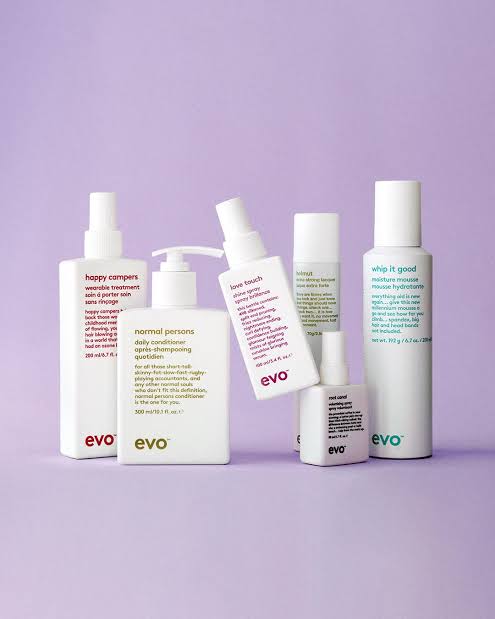 Collection of Evo Hair Essentials white skincare and haircare product bottles.