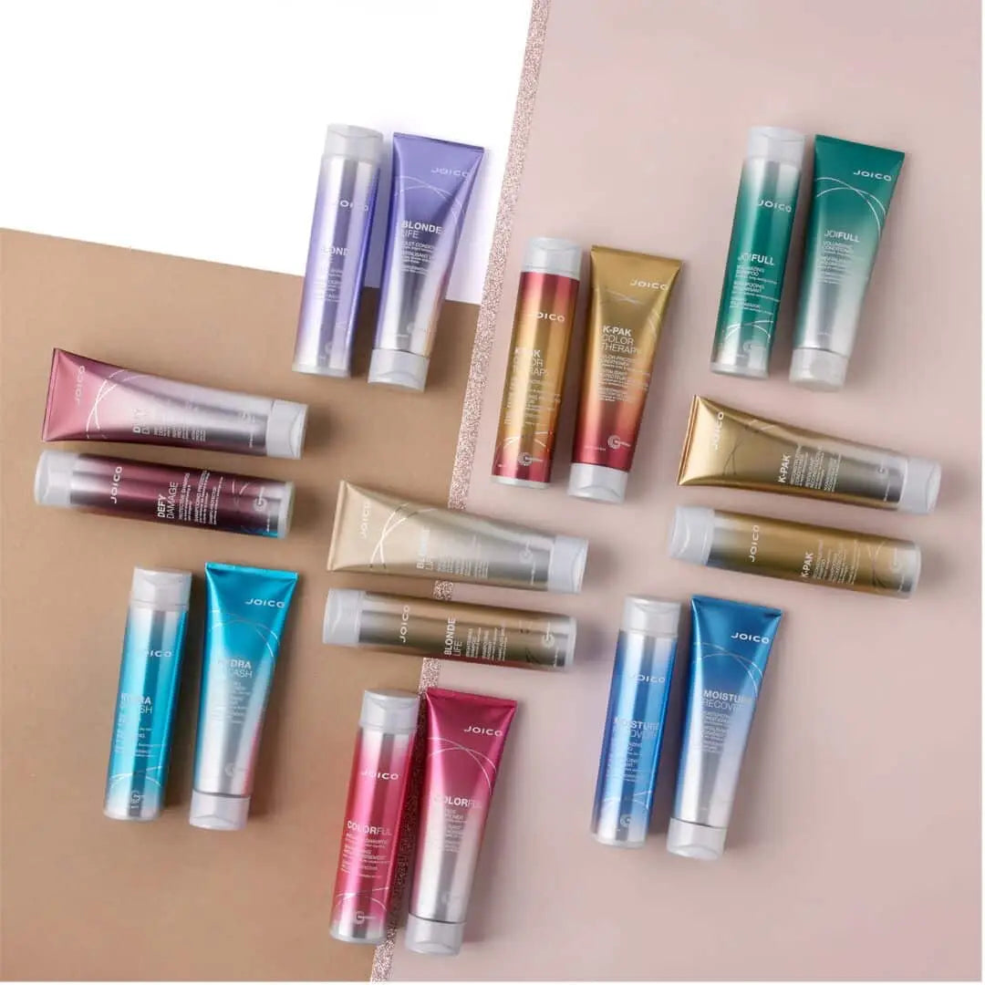 Colorful Joico hair products for addressing damaged hair and various hair concerns.