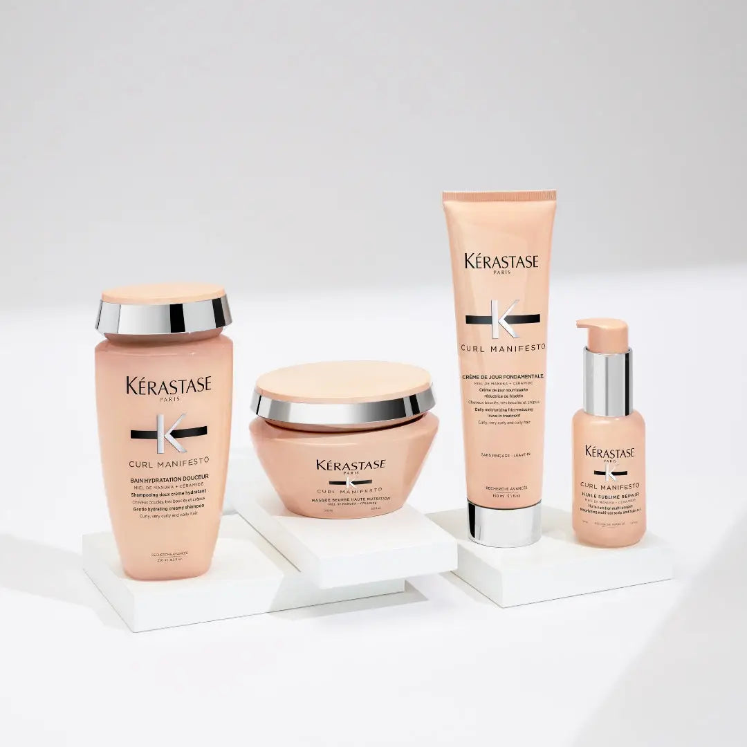 Kérastase hair care products in pink packaging from the Curl Manifesto range