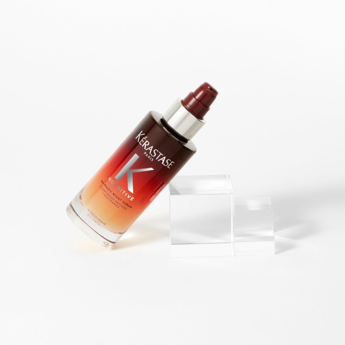 Kérastase luxury hair product bottle in gradient red-to-orange for damaged hair repair